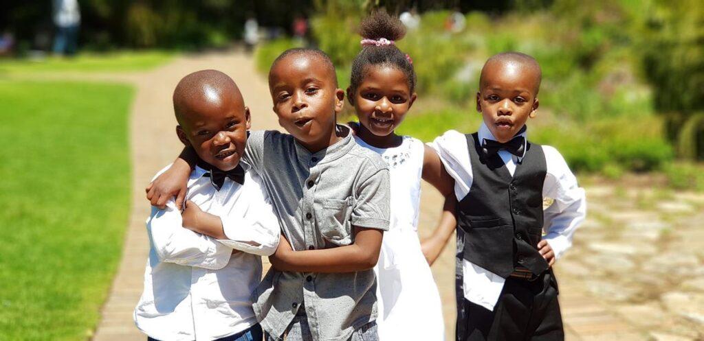 Four kids in formal clothing