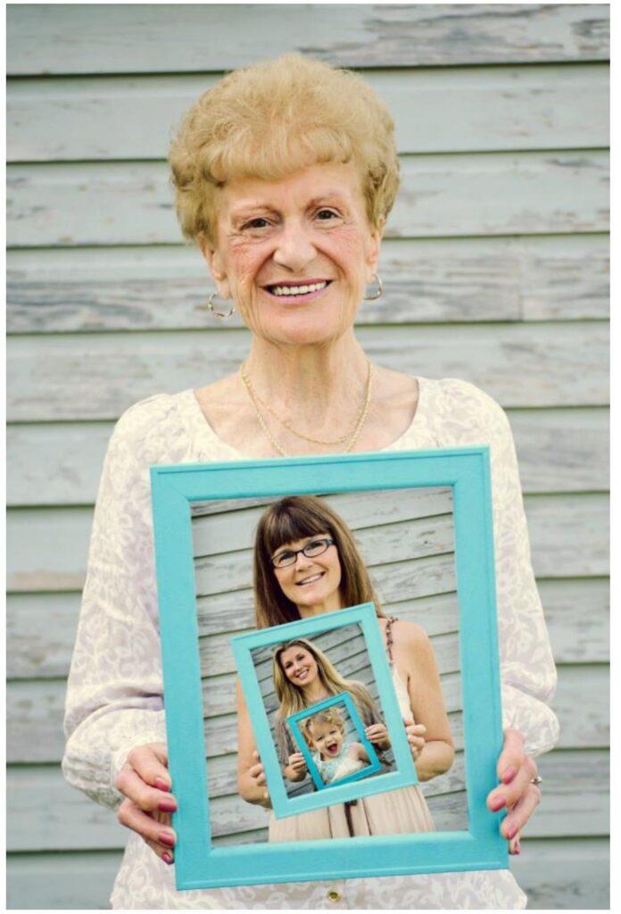 A woman holding a photo within a photo