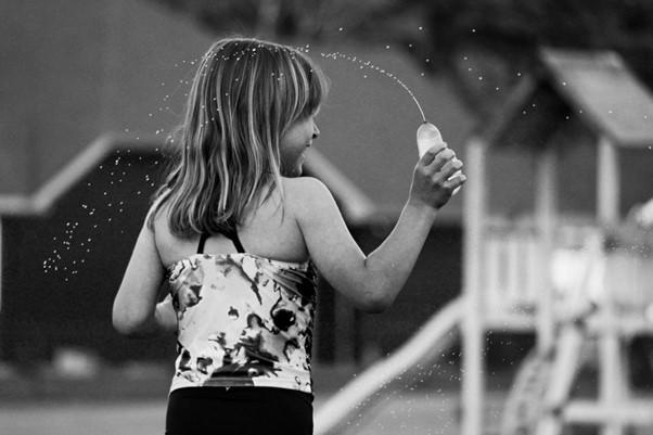 a girl playing water balloon