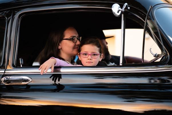 Family of three in a black car