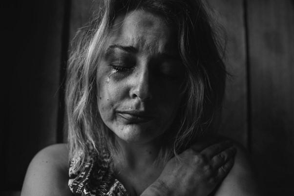Black and white photo of a woman crying
