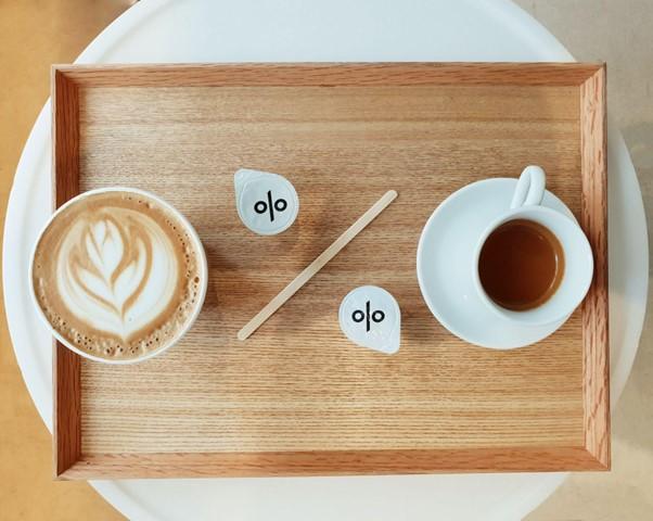 A percentage sign made using coffee cups and spoons